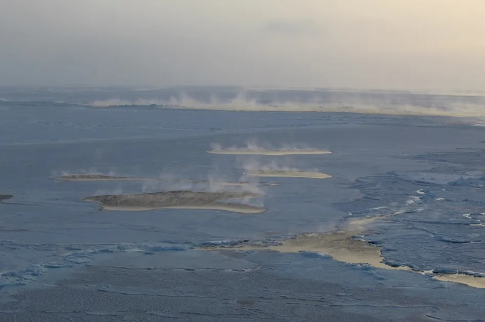 Sea smoke in leads in between sea ice northeast of Svalbard in March 2021, during a Nansen Legacy research expedition with RV Kronprins Haakon, illustrating the heat exchange between the cold atmosphere and relatively warmer ocean. 