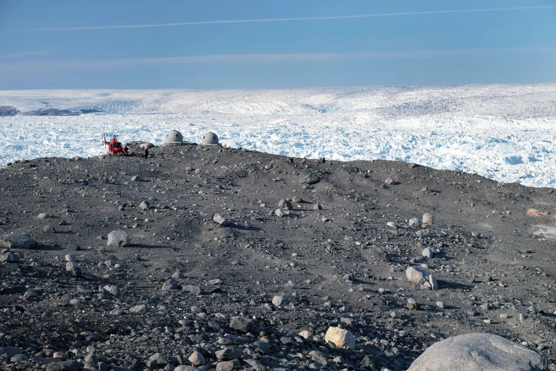 Greenland air helicopter and research instrument dwarfed by massive Greenland glacier