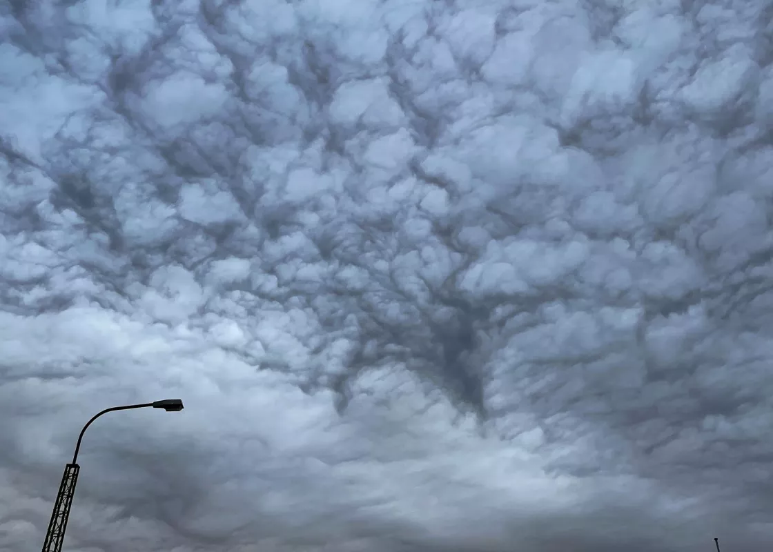 Asperitas clouds linger over the southern Greenland town of Narsaq on August 22, 2023. 