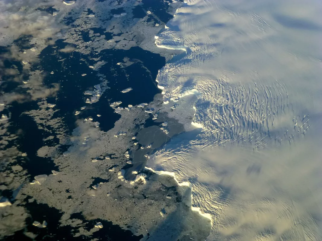 The edge of an ice shelf stretches out to the ocean off of Adelaide Island near the Antarctic Peninsula. The photo was taken during NASA’s IceBridge mission. Credit: Maria-Jose Vinas, NASA