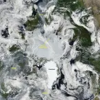 This true color composite image from the NASA Moderate Resolution Imaging Spectroradiometer (MODIS) on July 16 shows the North Pole at the center of the image, with Greenland pointing down.