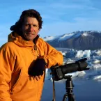 James Balog, founder and director of the Extreme Ice Survey and the Earth Vision Institute, leans on his camera while photographing ice in the field at Jökulsárlón, Iceland. 